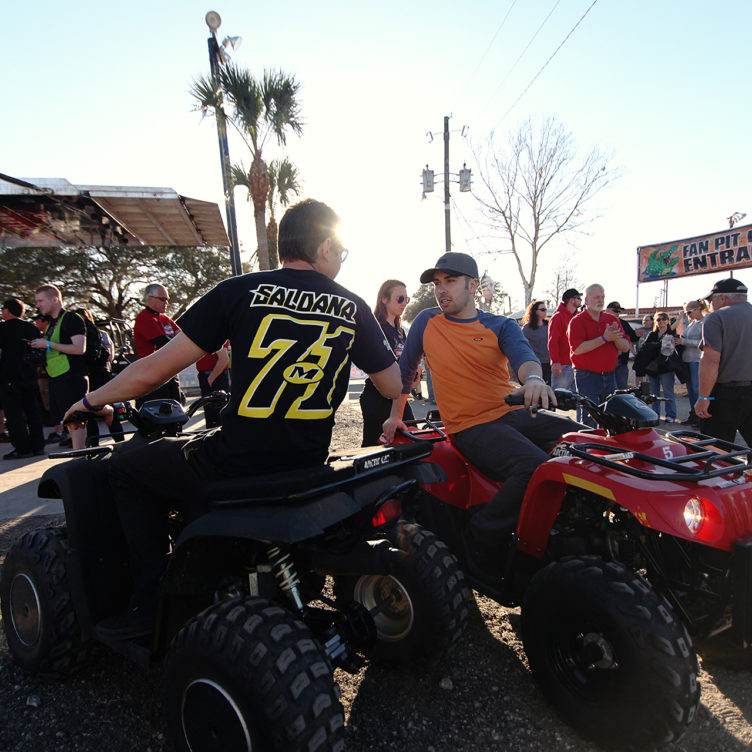R.J. Johnson and David Gravel hang out on their 4-wheelers after the 5pm driver's meeting.( Jeffrey Turford / TDP )