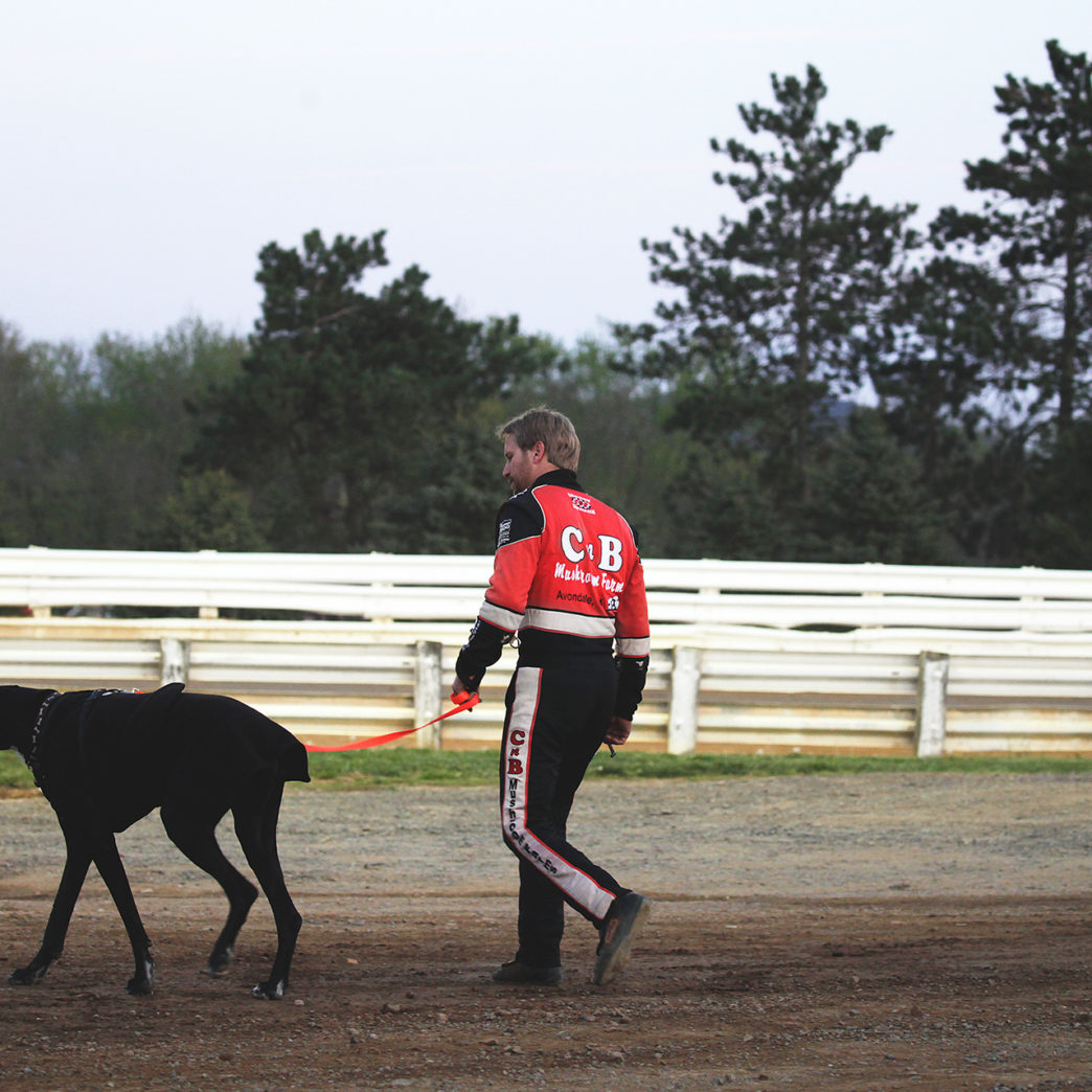 Blane Heimbach walks his dog before the feature race at Selinsgrove Speedway during the Arctic Cat All Stars Circuit event in Pennsylvania–2016. ( Jeffrey Turford / TDP )