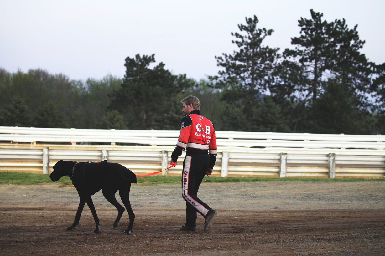 Blane Heimbach walks his dog before the feature race at Selinsgrove Speedway during the Arctic Cat All Stars Circuit event in Pennsylvania–2016. ( Jeffrey Turford / TDP )