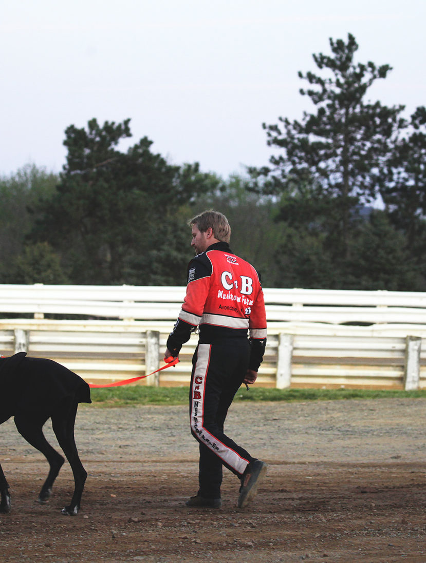 Blane Heimbach walks his dog before the feature race at Selinsgrove Speedway during the Arctic Cat All Stars Circuit event in Pennsylvania–2016. ( Jeffrey Turford / TDP )