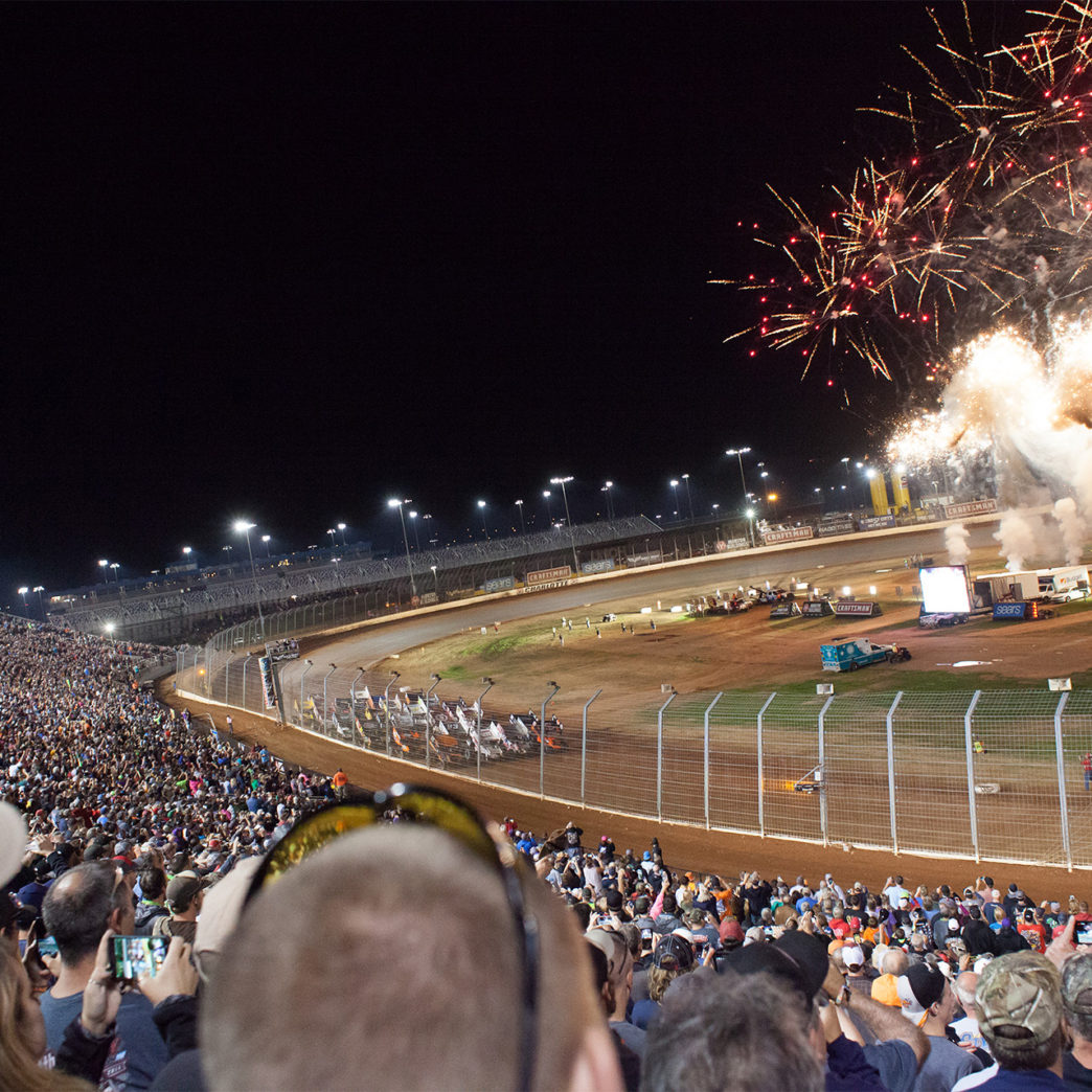 Fireworks light-up the 19 car field, in anticipation for the green, during the Feature race Saturday night, Day 2 of The Bad Boy Off Road World of Outlaws World Finals at The Dirt Track at Charlotte, in North Carolina 2016. ( Jeffrey Turford / TDP )