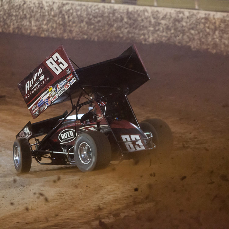 No. 83 Joey Saldana on the gas through turns 3 and 4 in Heat 2 on the final night of the 2016 WoO World Finals at The Dirt Track at Charlotte. Saldana placed 2nd in his heat to collect a transfer spot to the Feature at The 2016 World of Outlaws World Finals in North Carolina. ( Jeffrey Turford / TDP )
